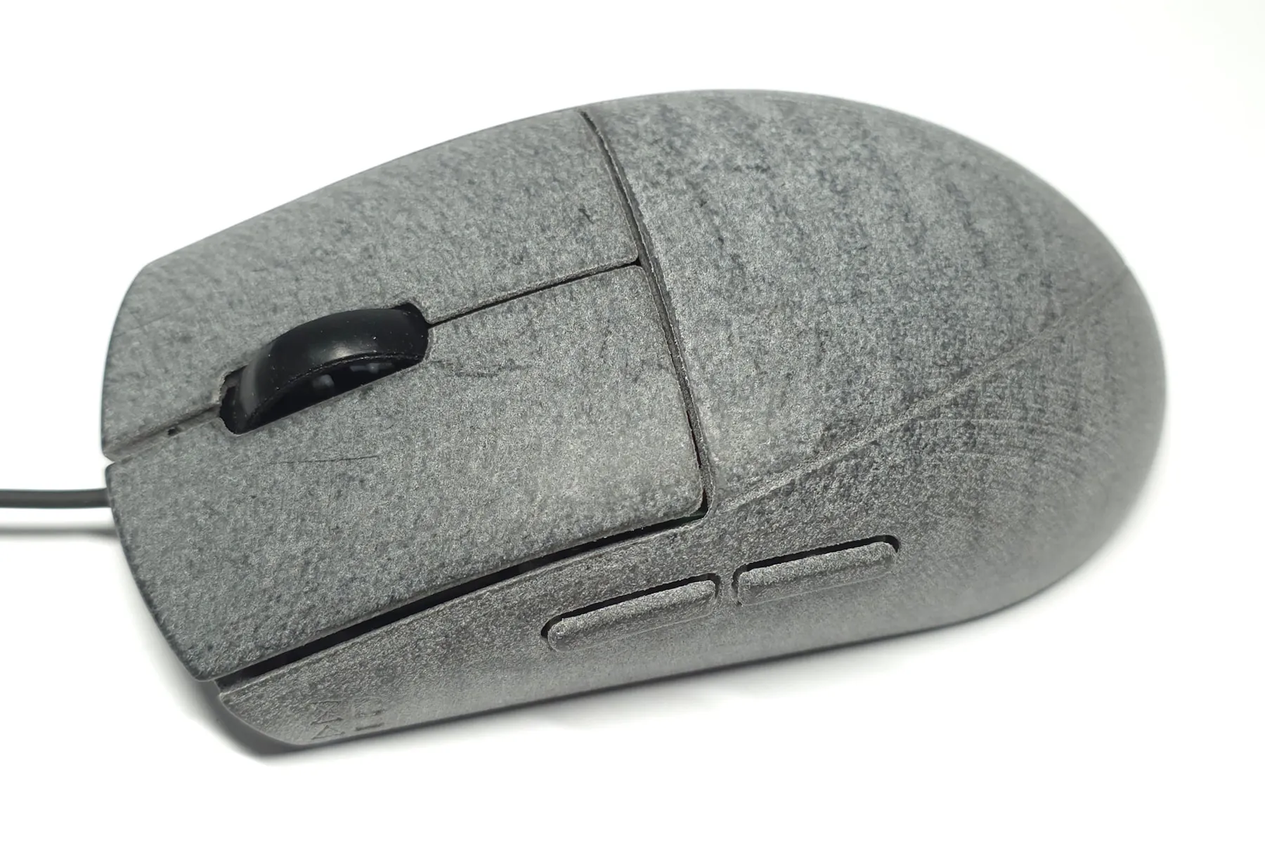 Photo of a polished gray XA25 shell, with the mottled gray of the printed material visible